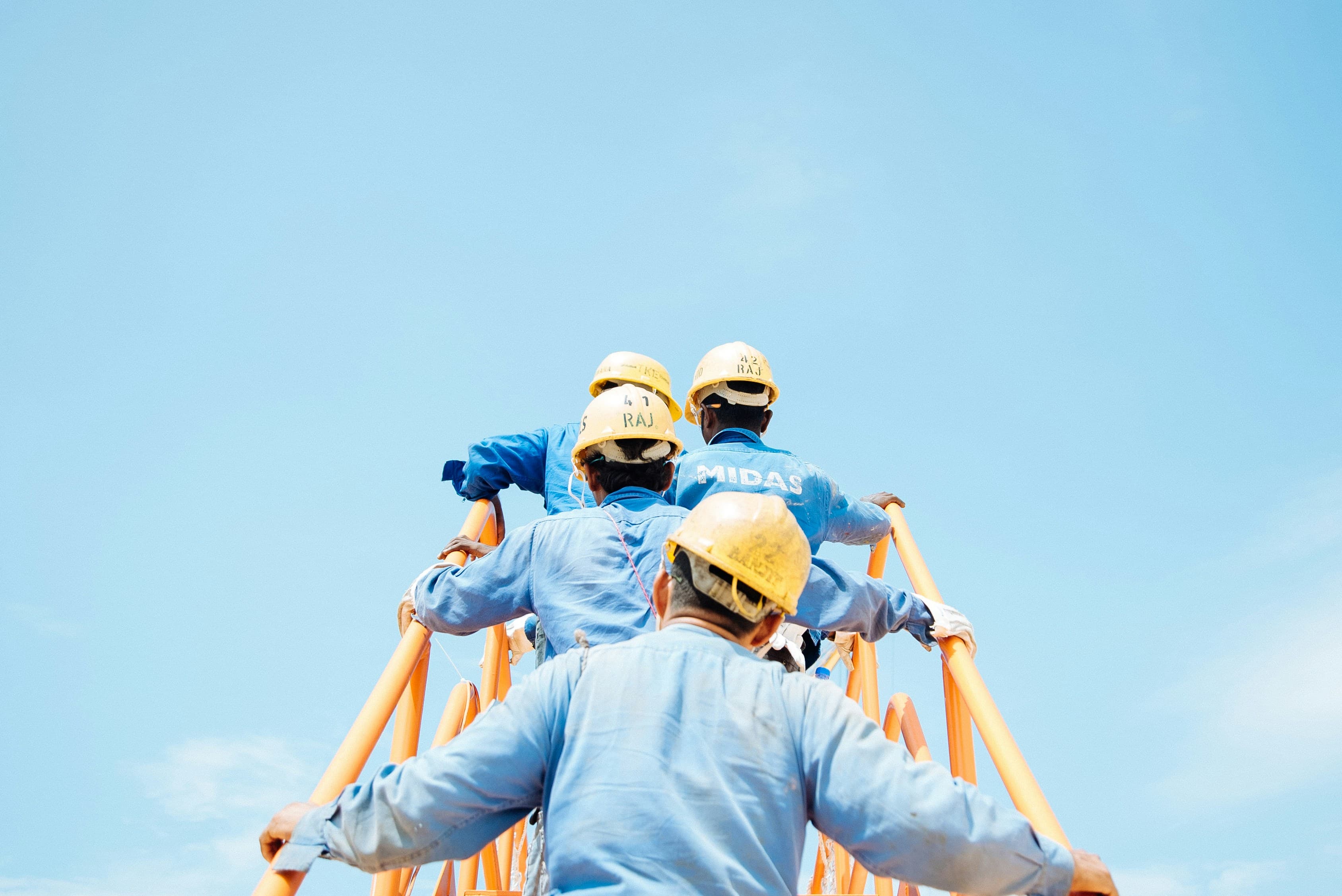Workers walking up ladder: Hero section